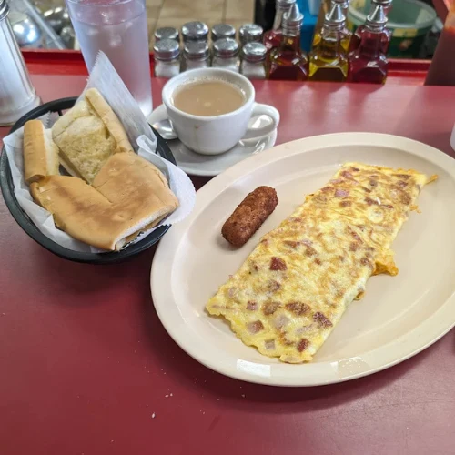 Latin Sabor Omelette - Signature omelette with ham, swiss cheese, onions, and green peppers.